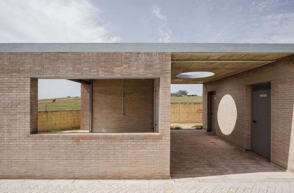 Load-bearing brick walls and geometric folds wrap up this soccer field facility in Seville
